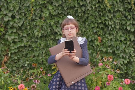 Adorable little girl taking a photo of herself on beautiful summer day.Little girl photographs...