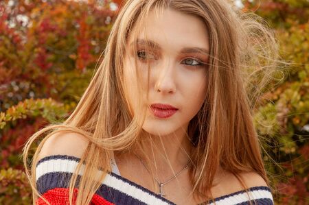 Pretty woman blonde posing for photo session.City walk in warm sunny autumn weather. Girl at sunset....