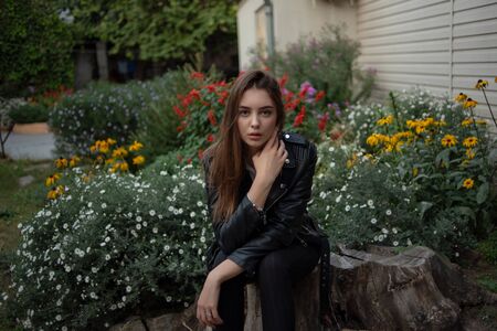 Beautiful young girl on a background of blooming flowers.