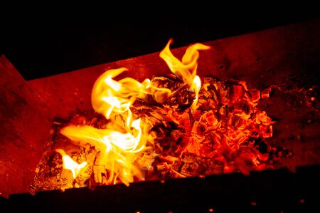 Bonfire Night. Bonfire at night. Ignition of firewood in the grill for cooking at the stake in the evening. The light of fire in the evening.A series of photos of a bonfire on a dark background.の写真素材