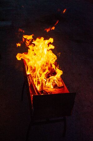 Bonfire Night. Bonfire at night. Ignition of firewood in the grill for cooking at the stake in the evening. The light of fire in the evening.A series of photos of a bonfire on a dark background.の写真素材