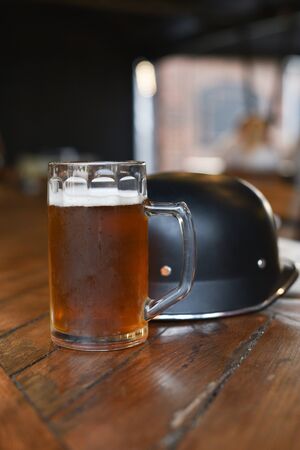 Glass of beer on wooden table. Beer in a glass. Beer in a glass at a pub