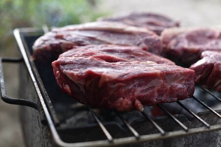 Chuck roll steak. grilled chuck roll. Cooking meat by a professional cook on a bonfire in the fresh...