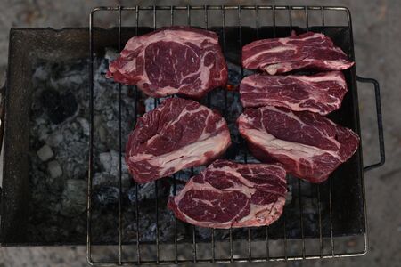 Chuck roll steak. grilled chuck roll. Cooking meat by a professional cook on a bonfire in the fresh air. Camping and grilling meat. Delicious hot steaks. steaks during cooking. meat for a restaurantの写真素材