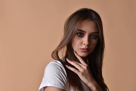 Gorgeous brunette with plump natural lips.Model shot in the studio. Fashion, beauty, glow.Closeup...