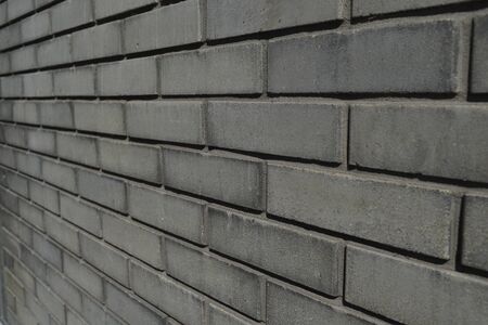 texture: old cracked brick wall painted in paint. Brick wall texture. The texture of the brick is gray.の写真素材
