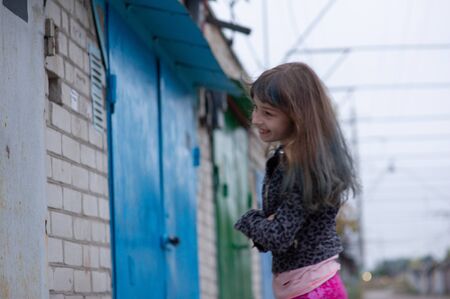 Portrait of nine year old girl. The child is walking in the fresh air. Teenager with blue strands on her hair. The girl with brown hair. A series of photos of a girl of 8 or 9 years oldの写真素材