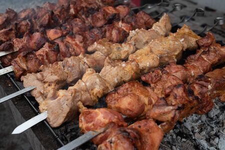 Grilled kebab cooking on metal skewer. Roasted meat cooked at barbecue. BBQ fresh beef meat chop slices. Traditional eastern dish, shish kebab. skewers on skewers.Roasted meat cooked at barbecue.BBQの写真素材