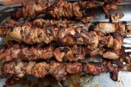 Grilled kebab cooking on metal skewer. Roasted meat cooked at barbecue. BBQ fresh beef meat chop slices. Traditional eastern dish, shish kebab. skewers on skewers.Roasted meat cooked at barbecue.BBQの写真素材