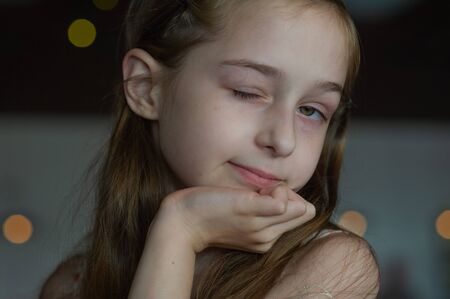 Portrait of a 9 years old female child, portrait concept of a child. Close-up face of beautiful girl 8-9 years old. Concept child teenager. A girl with long blond hair. Girl 9 years old in a cafeの写真素材