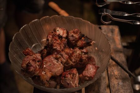 Close-up of grilling tasty dish on barbecue. Process of cooking yummy shashlik in nature. Delicious...