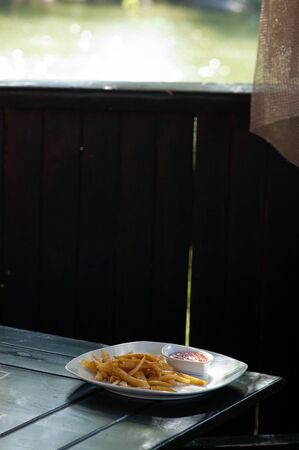 french fries, forks, table. French fries on an outdoor cafe table. French fries, fast food, outdoor...