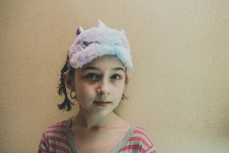 girl with straight hair with a soft white sleeping patch Unicorn on her face. Girl in a unicorn...