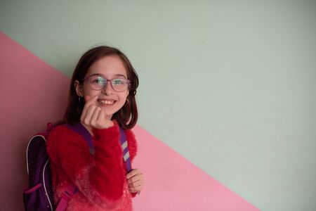 9 years old schoolgirl with glasses in school. Seriously disposed student. Modern children. A girl...