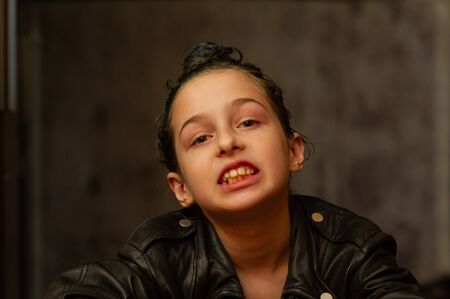Portrait of nine year old girl. Teenager with blue strands on her hair. A series of photos of a girl...