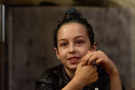 Portrait of nine year old girl. Teenager with blue strands on her hair. A series of photos of a girl...