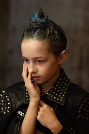 Portrait of nine year old girl. Teenager with blue strands on her hair. A series of photos of a girl...