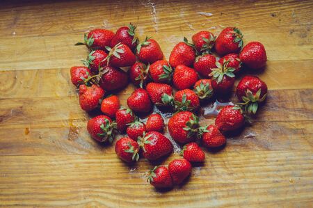 Fresh strawberries on old wooden background. Strawberries on a wooden board. Strawberries in the...