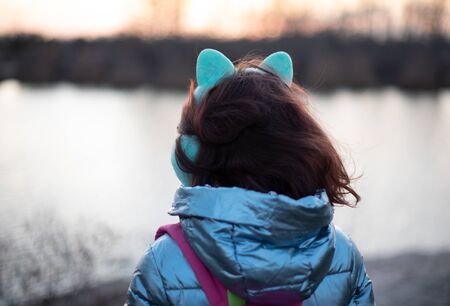 Portrait of beautiful young woman. Plein air photo shoot near river at winter. Portrait of a...