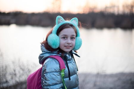 Portrait of beautiful young woman. Plein air photo shoot near river at winter. Portrait of a...