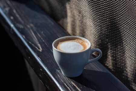 Coffee selective focus. White cup with cappuccino on the nature. White cup with cappuccino, coffee,...