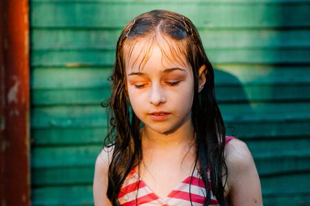 Girl in a swimsuit in the summer. Sunset. Teenager 9 years old. 10 years old. Pool in the forest or...