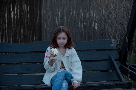 A happy little girl looking at an eastern cake. Easter concept. Traditional homemade easter and girl. Easter holidays breakfast concept. Traditional home decorated Easter cake. Happy easter.の写真素材