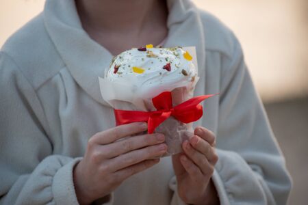 A happy little girl looking at an eastern cake. Easter concept. Traditional homemade easter and girl. Easter holidays breakfast concept. Traditional home decorated Easter cake. Happy easter.の写真素材