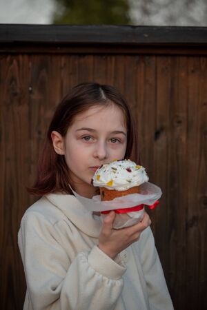 A happy little girl looking at an eastern cake. Easter concept. Traditional homemade easter and...