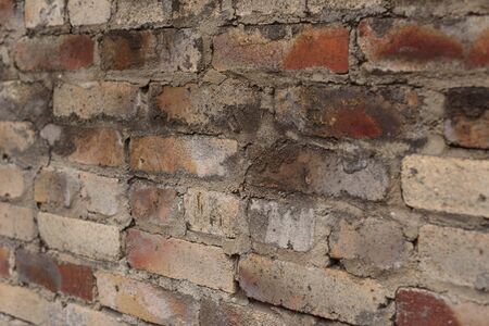 Weathered stained old brick wall background. Brick wall. The brick is red. The texture of the wall...
