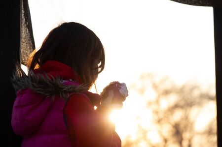 A happy little girl looking at an eastern cake. Easter concept. Traditional homemade easter and girl. holidays breakfast concept. Traditional home decorated Easter cake. Happy easter.の写真素材