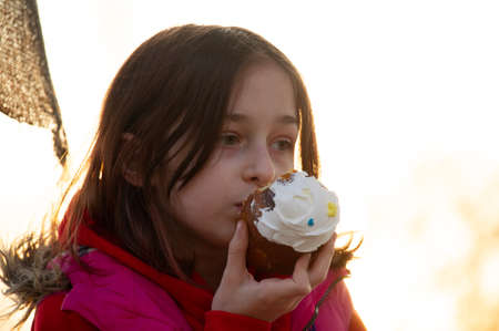 A happy little girl looking at an eastern cake. Easter concept. Traditional homemade easter and...