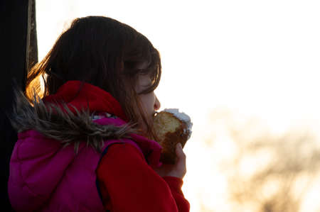 A happy little girl looking at an eastern cake. Easter concept. Traditional homemade easter and...