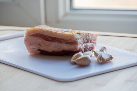 Garlic and bacon.Bacon and garlic. Bacon and garlic on a table on a blackboard. Food photography.