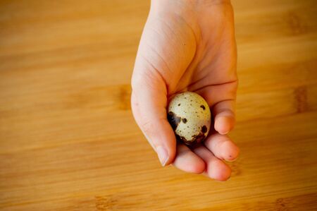 quail eggs in a wooden board. Quail eggs. Healthy nutrition, food photography. Happy easter. Organic...