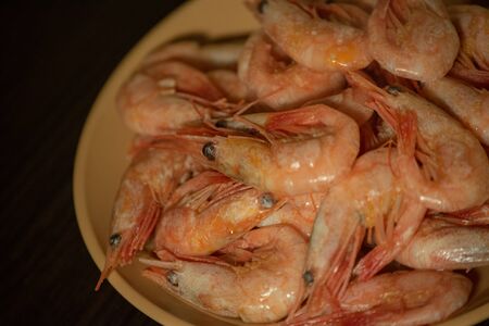 shrimp boil. Boiled shrimps. spicy shrimps. Cooked Shrimp. a lot of boiled peeled shrimp. Concept of...