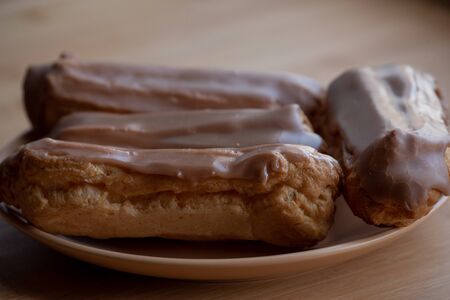 Custard cakes with cream. Custard cakes poured on top with brown and white sugar icing. Sweet treats...
