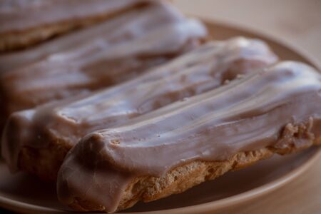 Custard cakes with cream. Custard cakes poured on top with brown and white sugar icing. Sweet treats...