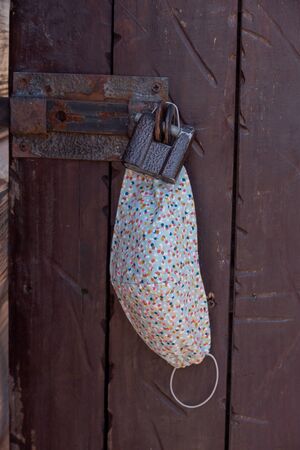 Corona virus protection. Individual respiratory protection. Protective mask hanging on the door....