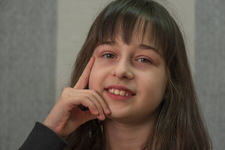 portrait of a little girl. Girl 9 years old. Girl after cutting bangs in a beauty salon. Portrait of a teenager.の写真素材