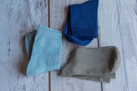 Socks of fine jersey. View from above. Many socks on a wooden background. Socks of different colors...