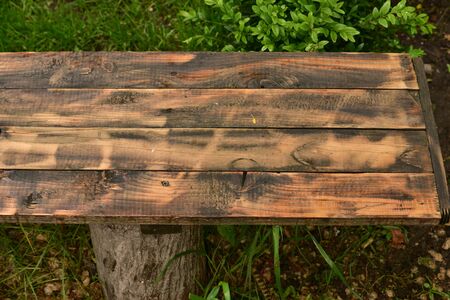 Dark black boards background with blotches of red color. Old wet wood texture pattern after rain....