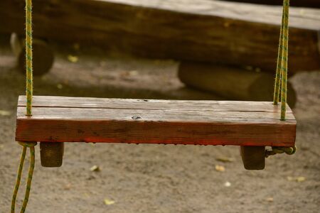 Wooden swing in the park. empty wooden swing in children playground.の写真素材