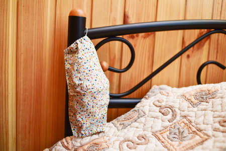 Protective mask near the bed. Protective mask in the bedroom. Infection and protection. Virus