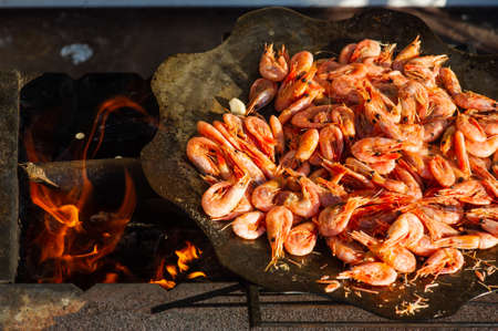shrimp. Shrimps are cooked in a pan over a fire. Bonfire seafood. Food photography