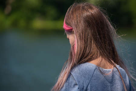 cute child girl portrait . Outdoor portrait of cute little girl in summer day. Portrait of a little girl with pink hair. Child 9-10 years old. Teenagerの写真素材