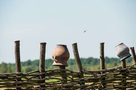 Fence wicker from the vine, texture, background. Wicker vine fence. woven vines texture embossed background. Organic woven willow wicker fence panel suitable for crafts, picnic or gardening backgroundの写真素材