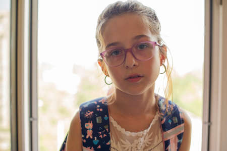Girl schoolgirl close-up portrait in glasses at school. Close up portrait of beautiful, pretty,...