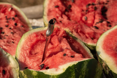 Pile of watermelons. Heap of watermelon at farmers market. Seasonal vitamins. Watermelon cut with a...