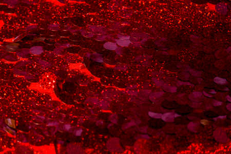 Red sequins pattern. Sparkling sequins background. Red sequin fabric for background. rectangular red shiny fabric with sequins, Christmas background. Sequins on Fabric, red Beads. Fashion Fabricの写真素材